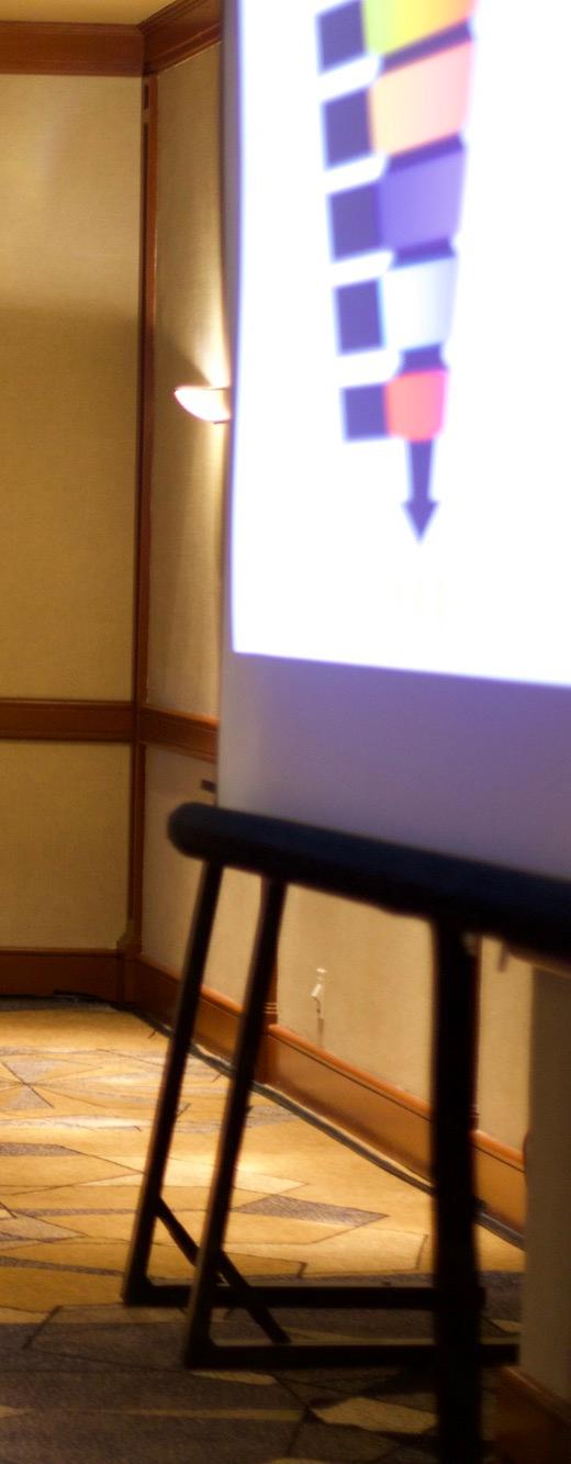Yamil Morales presenting at the front of a hotel ballroom