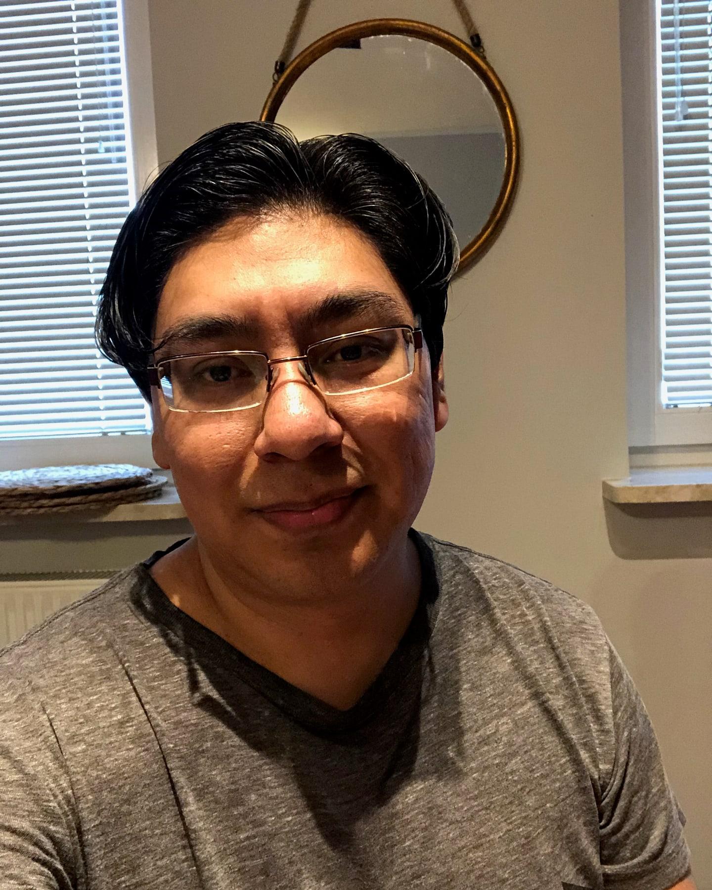 Yamil Morales smiling, in a grey T-shirt